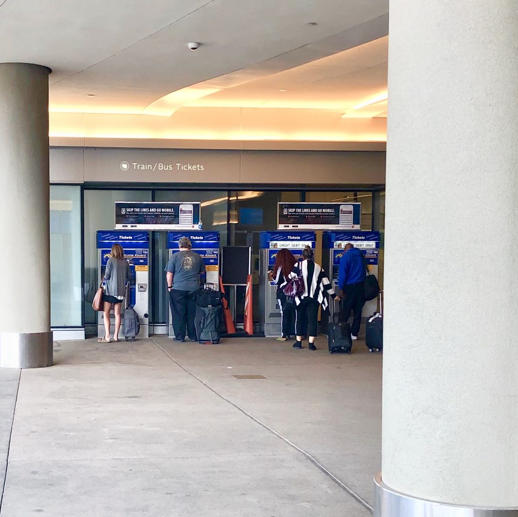 Joe buying train tickets at Denver International Airport